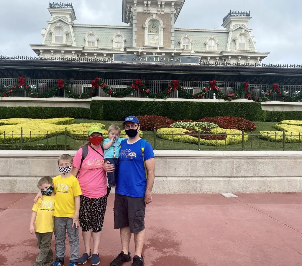family in front of magic kingdom
