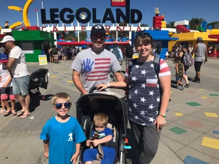 family in front of legoland california. 