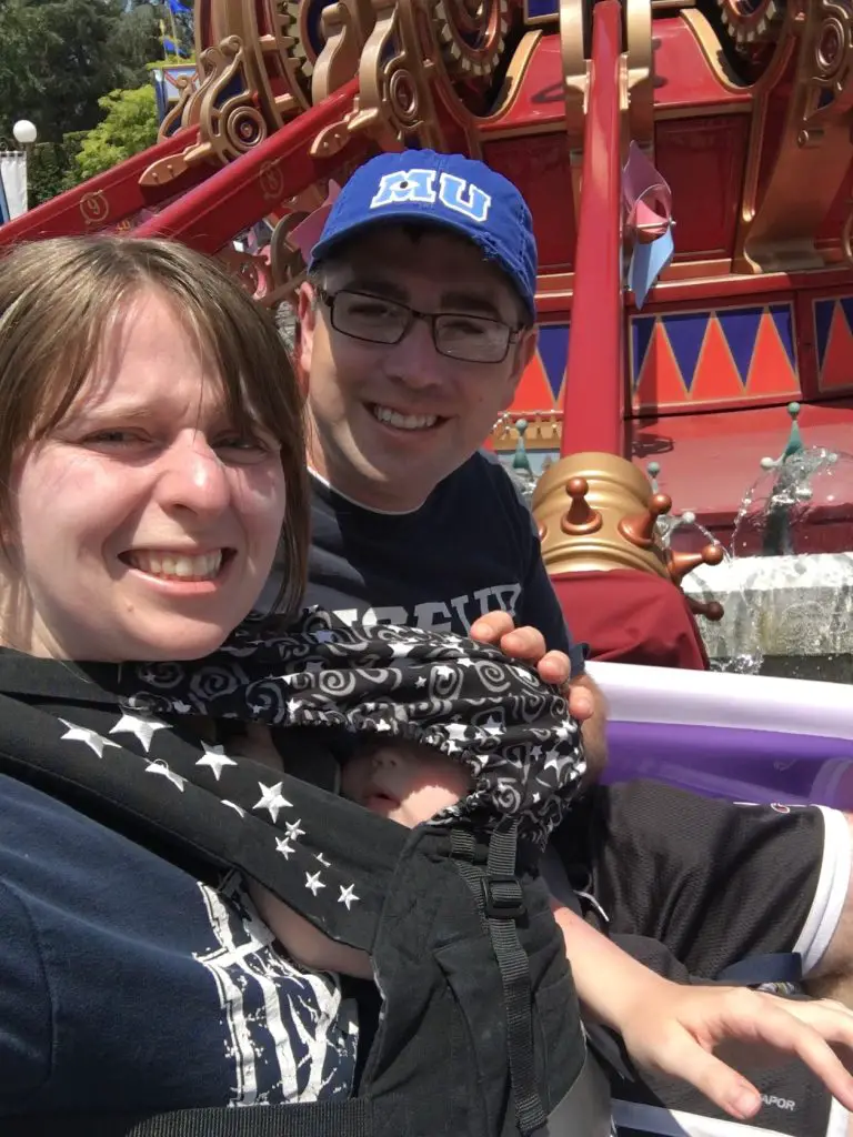 parents with baby on dumbo ride