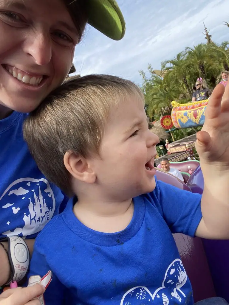 toddler with mom at disney world waving